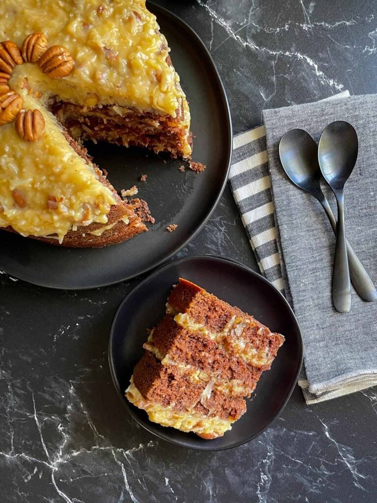 A slice of original Baker's German Chocolate Cake on a black plate.