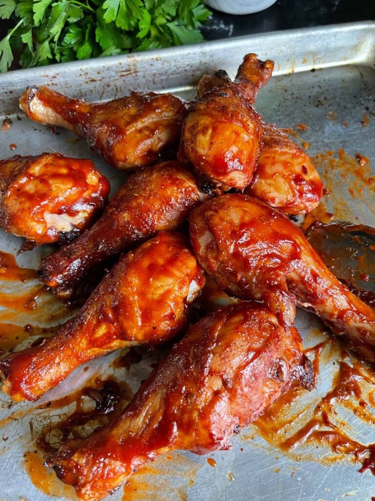 bbq chicken legs on a baking sheet.