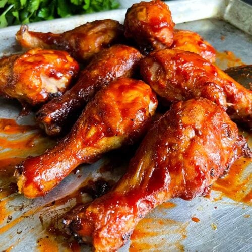 Bbq chicken legs on a baking sheet.