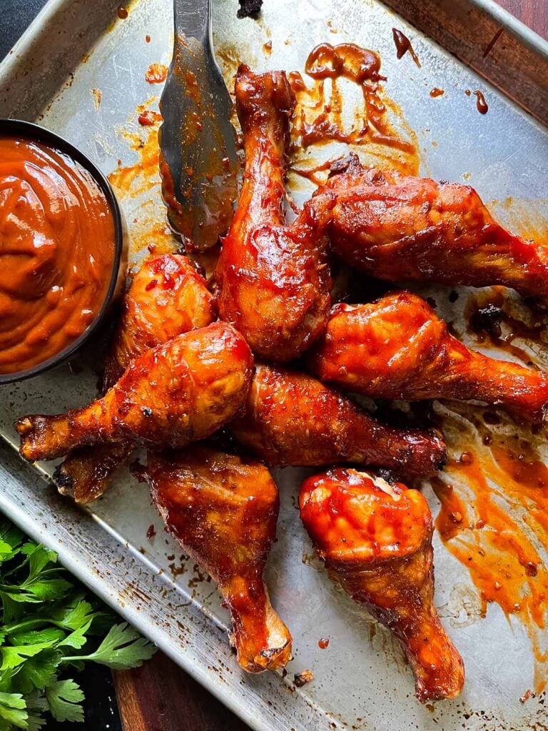 barbecue chicken legs on a baking sheet.