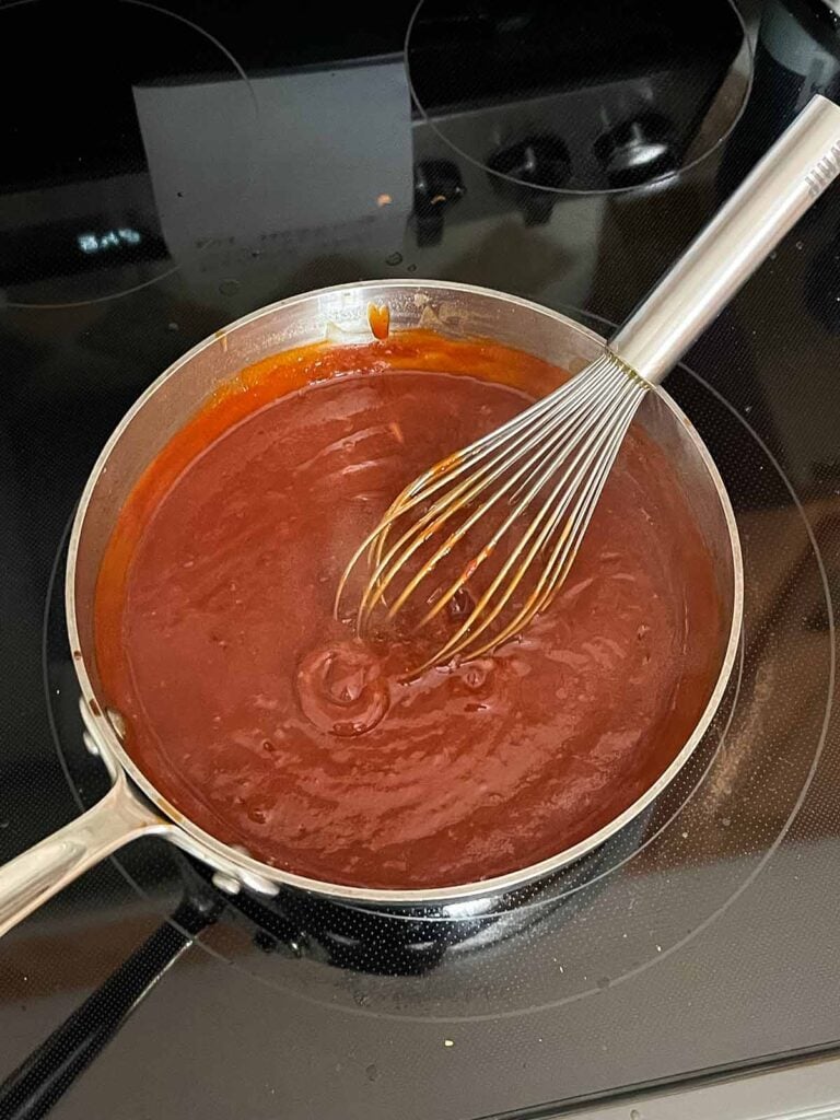 bbq sauce bubbling on the stovetop.