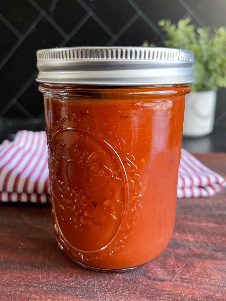 Homemade barbeque sauce in a mason jar.