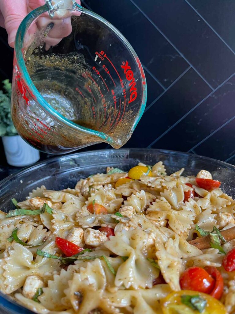 Vinaigrette being poured over the salad.