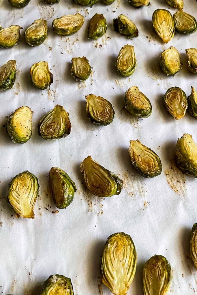 Roasted brussels sprouts on baking tray.