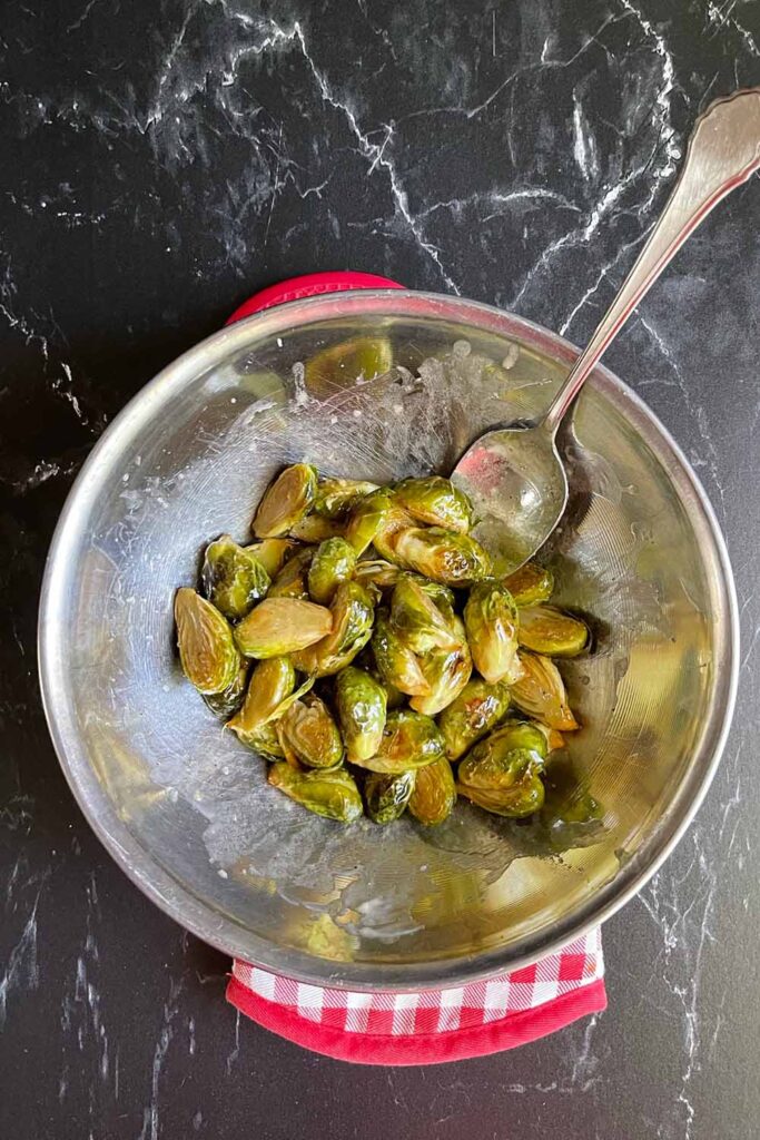 Brussels sprouts in a bowl with butter honey.