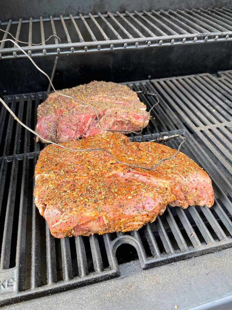 Two chuck roasts just placed into a smoker.