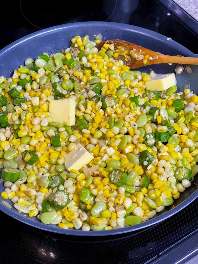 Corn, lima beans, peas, and butter added to the okra and onions for succotash recipe.