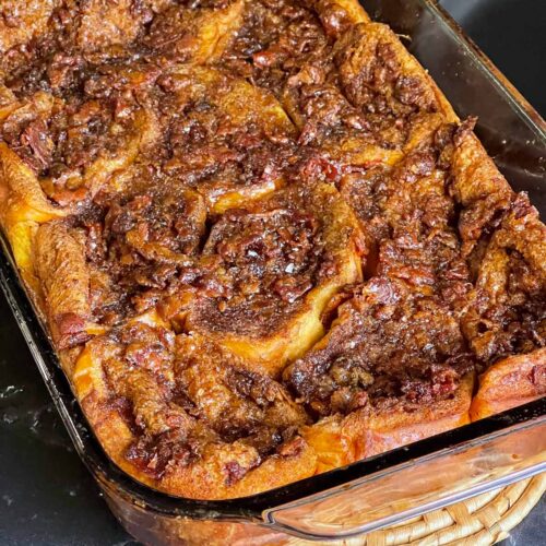 Overnight maple bacon french toast in a glass casserole dish.