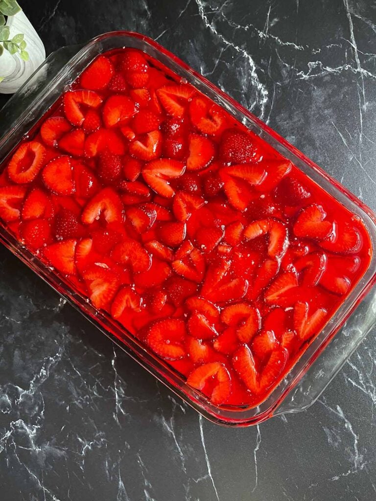 Strawberry pretzel salad made in a 9x13 pan, ready to go into the refrigerator to set up.