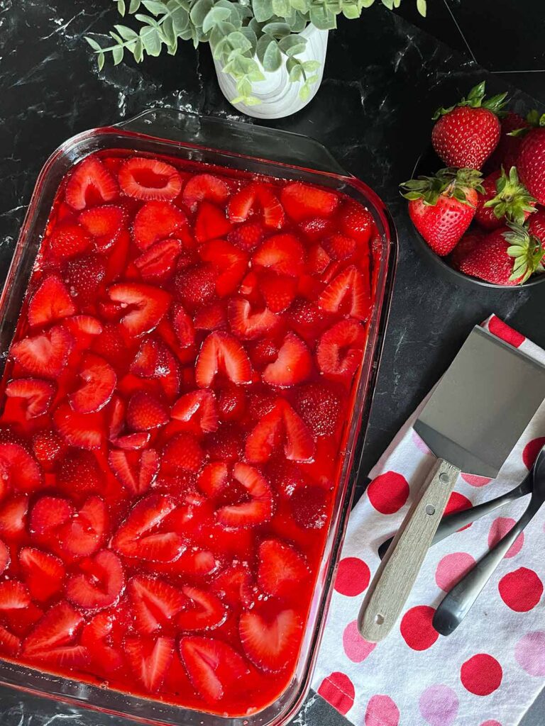 A dish full of strawberry pretzel salad.