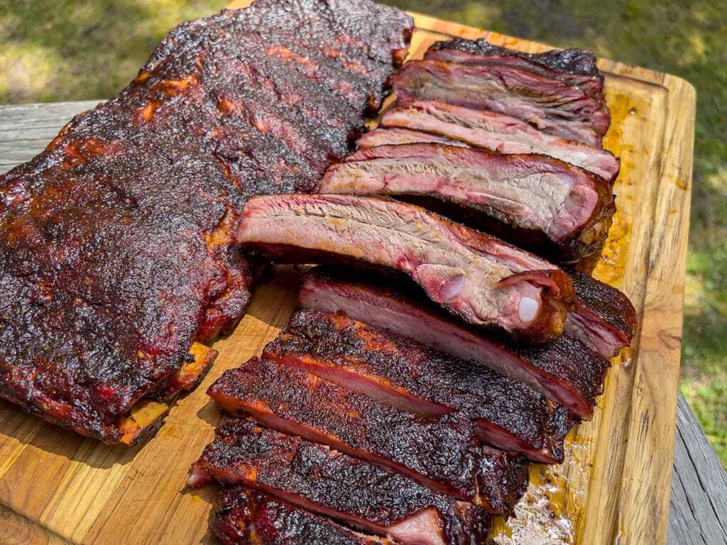 Two racks of St. Louis style ribs on a cutting board