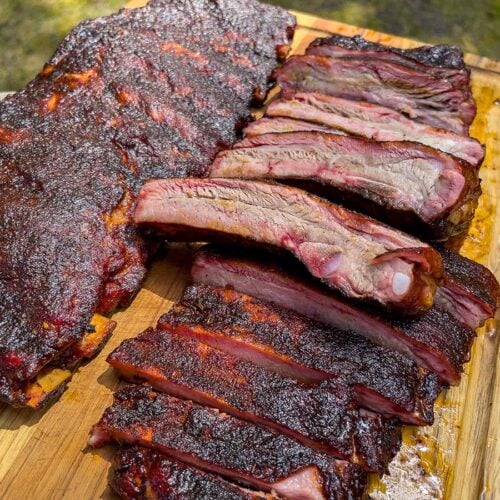Two racks of St. Louis style ribs on a cutting board