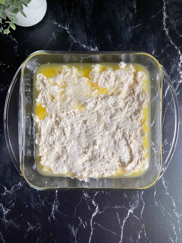 Dough spread evenly into the butter filled baking pan.