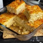 Butter swim biscuits in a glass baking dish.