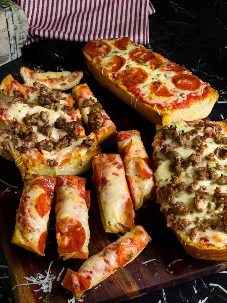 French bread pizza on a cutting board.