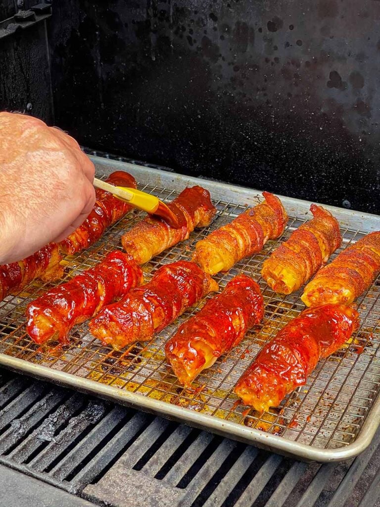 Applying barbecue sauce to the smoked shotgun shells.