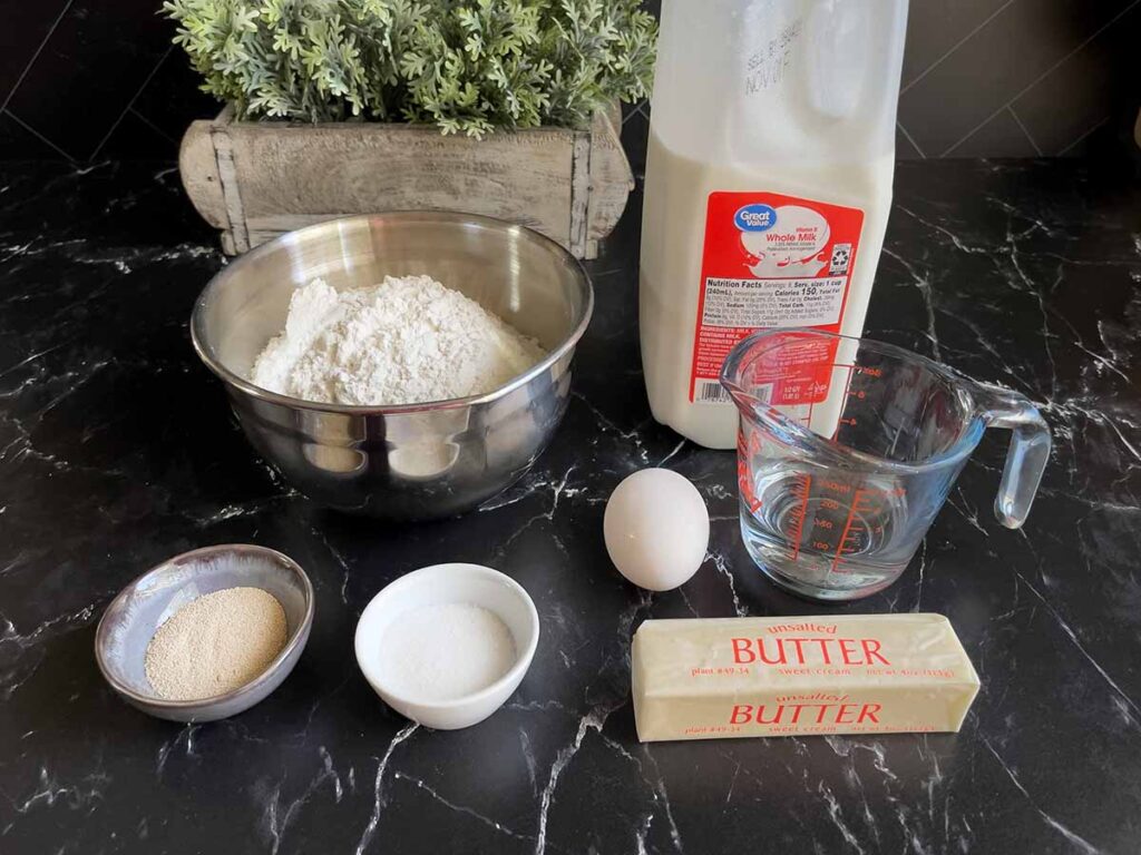 Ingredients for crescent rolls on a black surface.