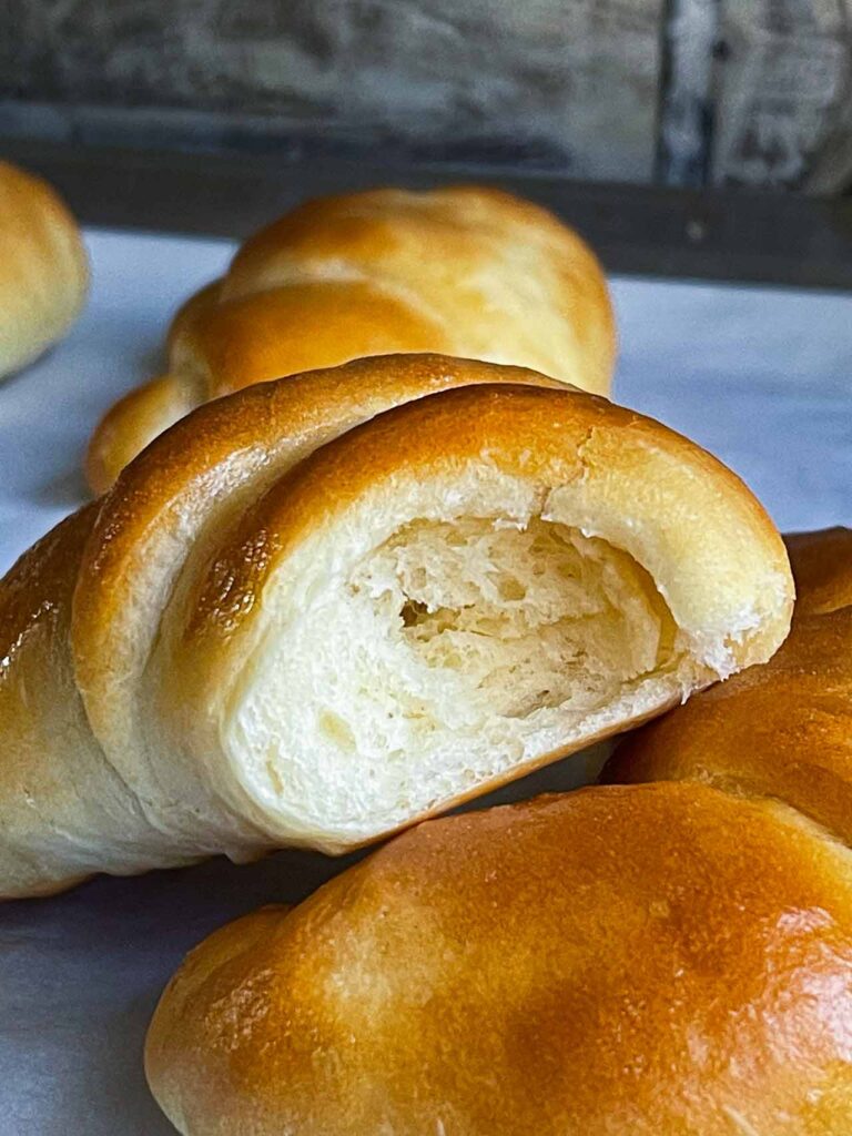 Crescent roll torn in half to show crumb.