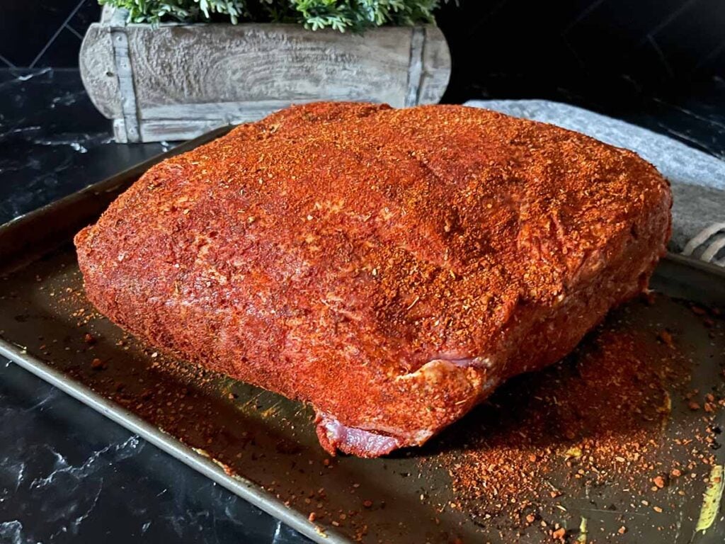 A pork butt with a memphis style rub applied. 