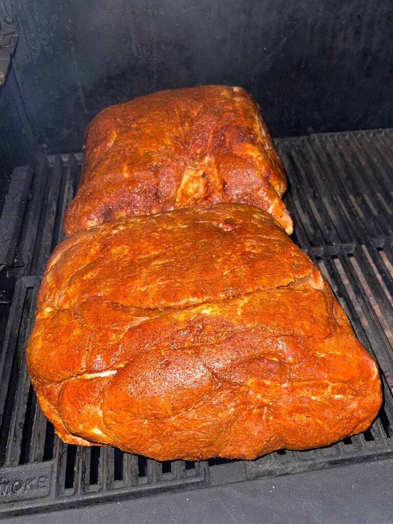 Two pork butts just placed into the smoker.