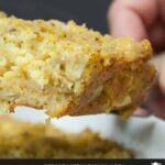 A slice of southern cornbread dressing lifted over the baking pan.