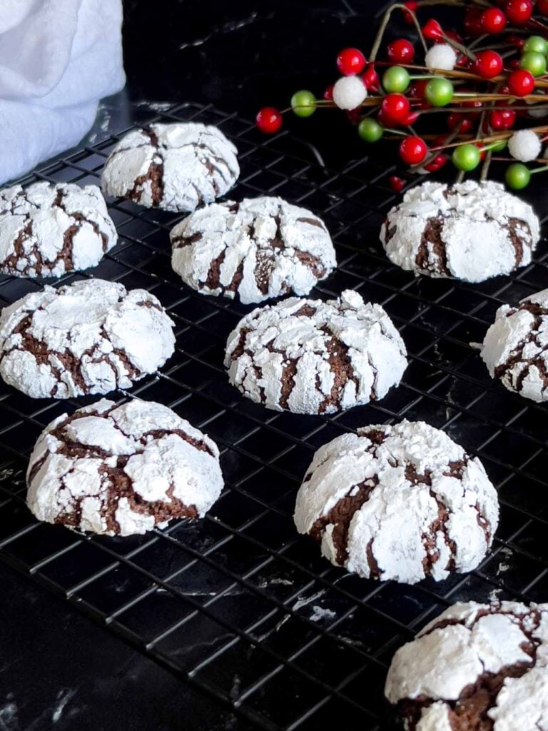 Chocolate crinkle cookies on a wire rack.