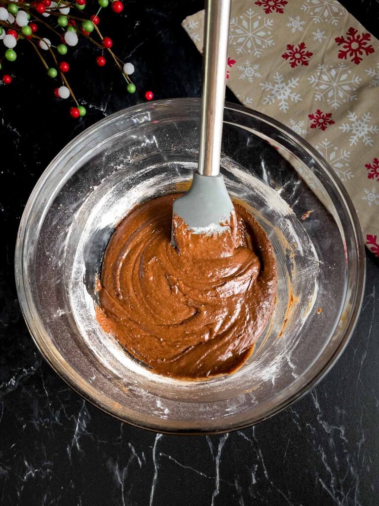 Chocolate crinkle cookies batter in a glass bowl,