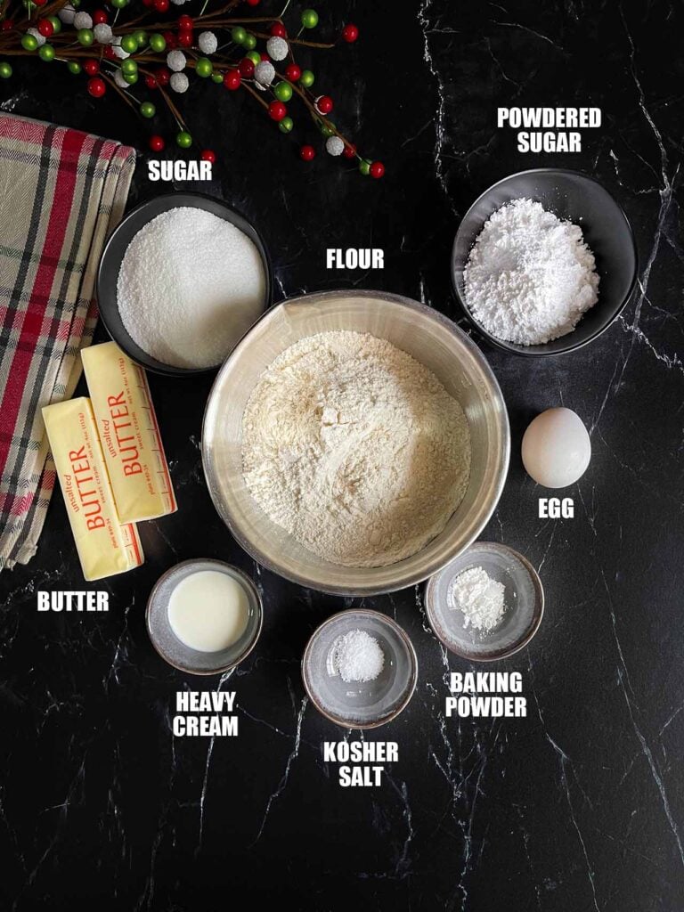 Ingredients for cut out sugar cookie recipe on a dark background.