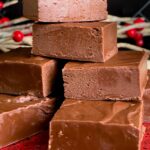 Extra dark chocolate fudge pieces stacked on a plate.