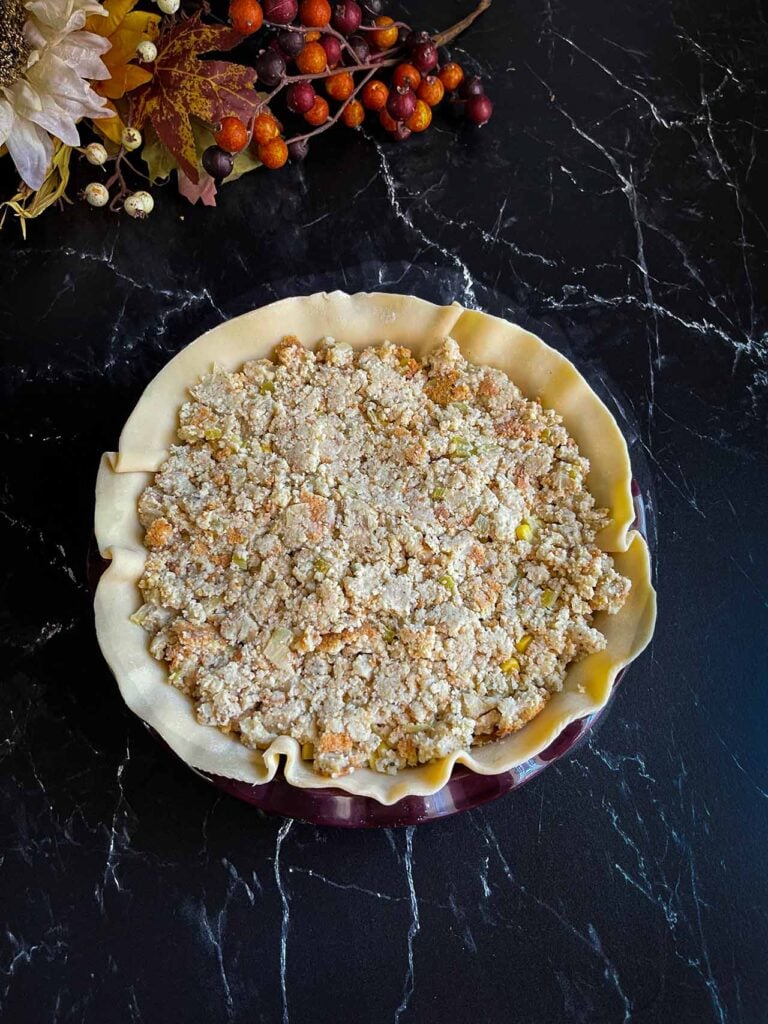 Layers of thanksgiving leftovers in a pie crust.