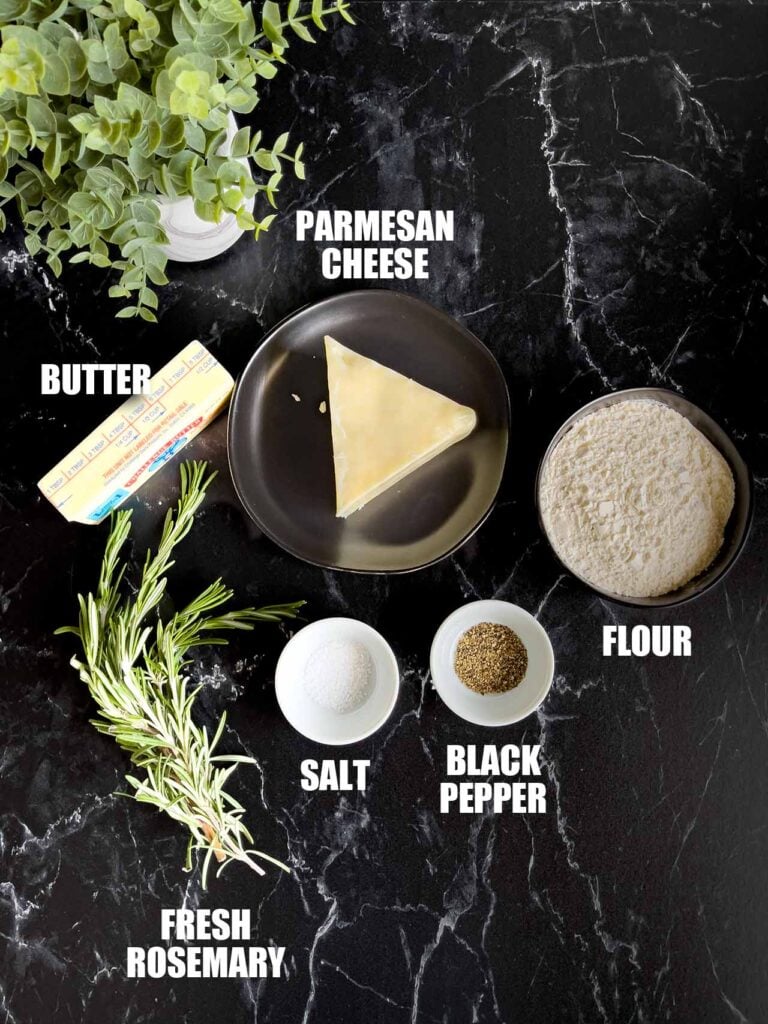 Ingredients for parmesan shortbread on a dark surface.