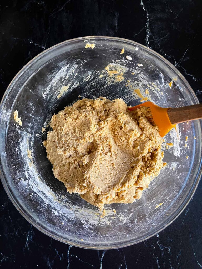 Peanut butter cup cookie dough mixed in a glass bowl.