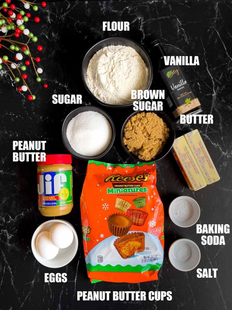 Peanut butter cup cookie ingredients on a dark surface.