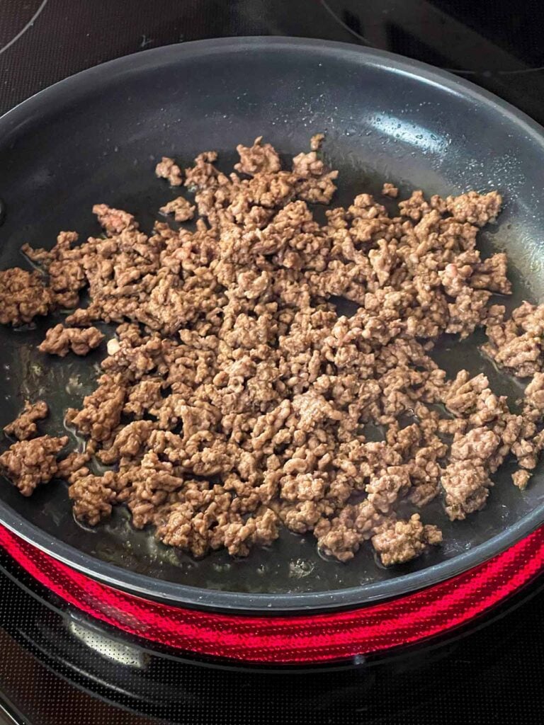 Cooked ground beef in a skillet.