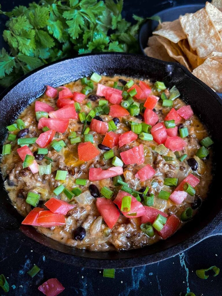 Queso fundido in a cast iron skillet.