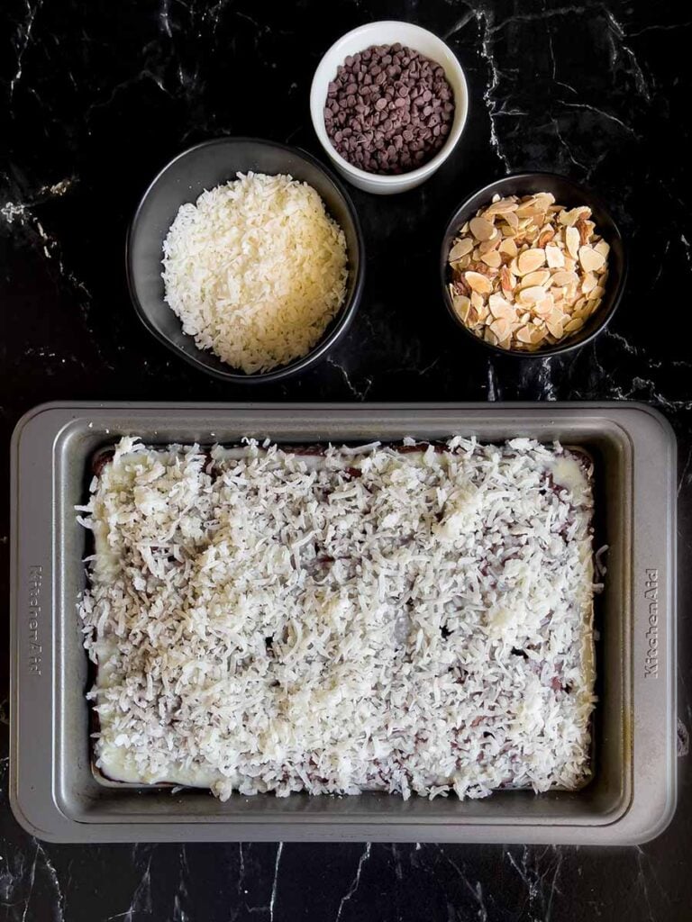 The shredded coconut sprinkled over the Almond Joy cake.