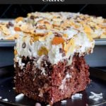 Almond Joy Cake is a rich and decadent chocolate cake, soaked with coconut cream sauce, and topped with sweet coconut, whipped cream topping, almonds, and semi-sweet chocolate chips.