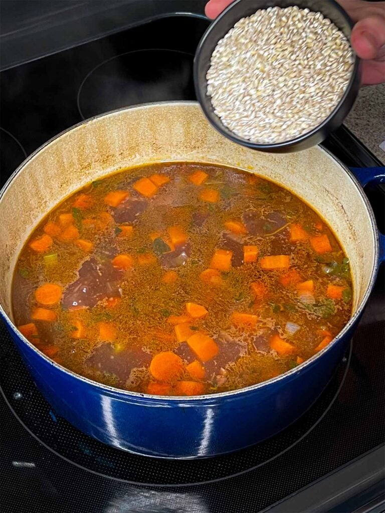 Pearl barley being added to the beef barley soup.