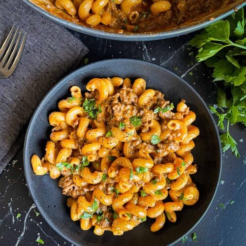 Homemade one pot hamburger helper in a dark bowl.