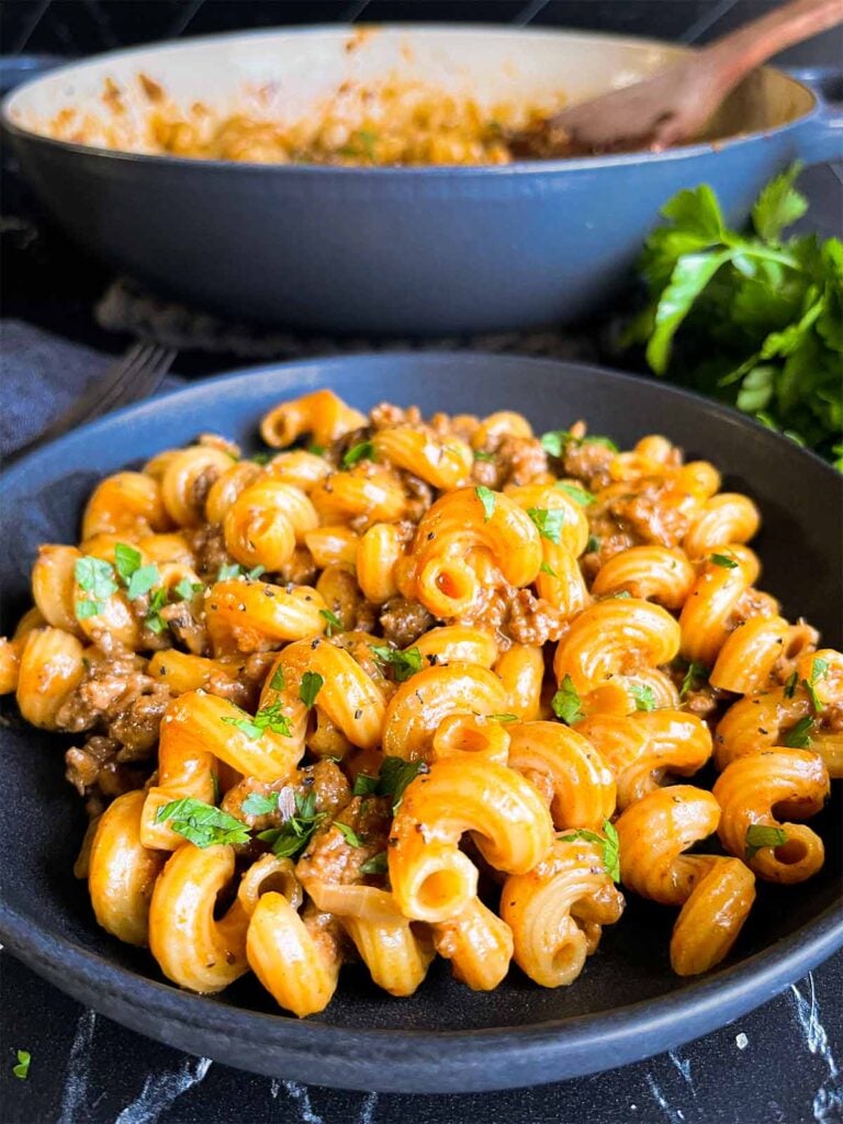 Homemade one pot hamburger helper in a dark bowl.