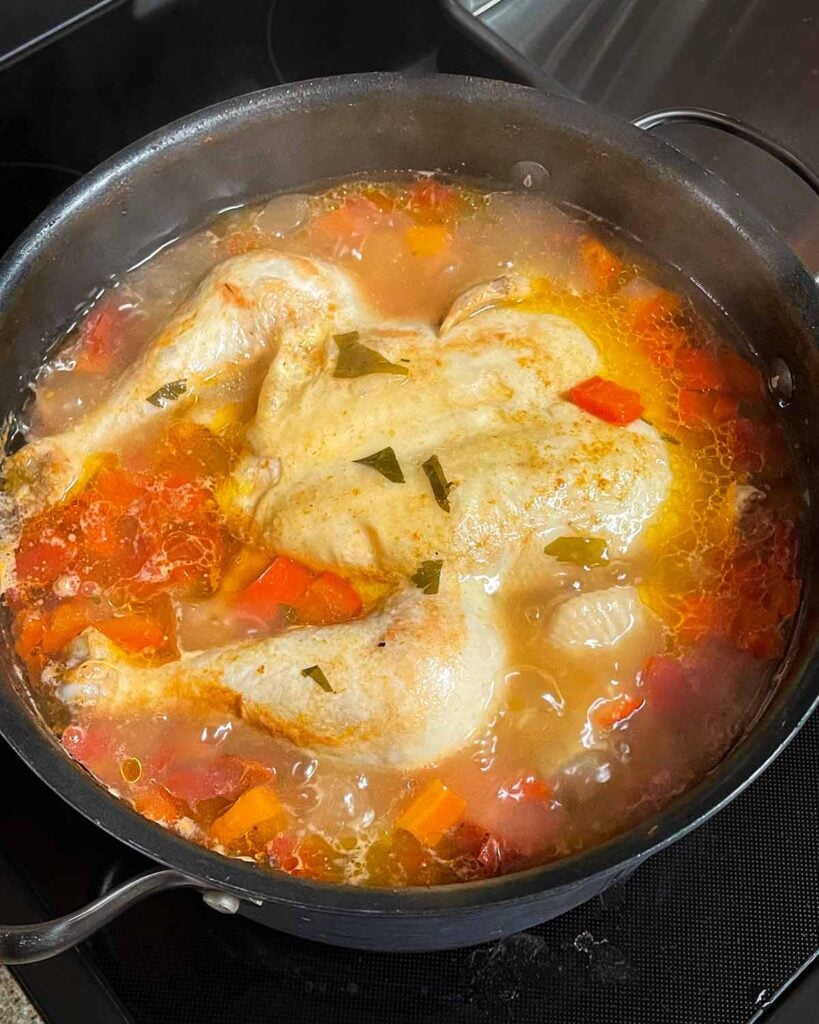 Simmering Sicilian chicken soup in a large stock pot.