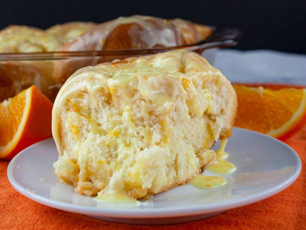 An orange roll on a white plate.