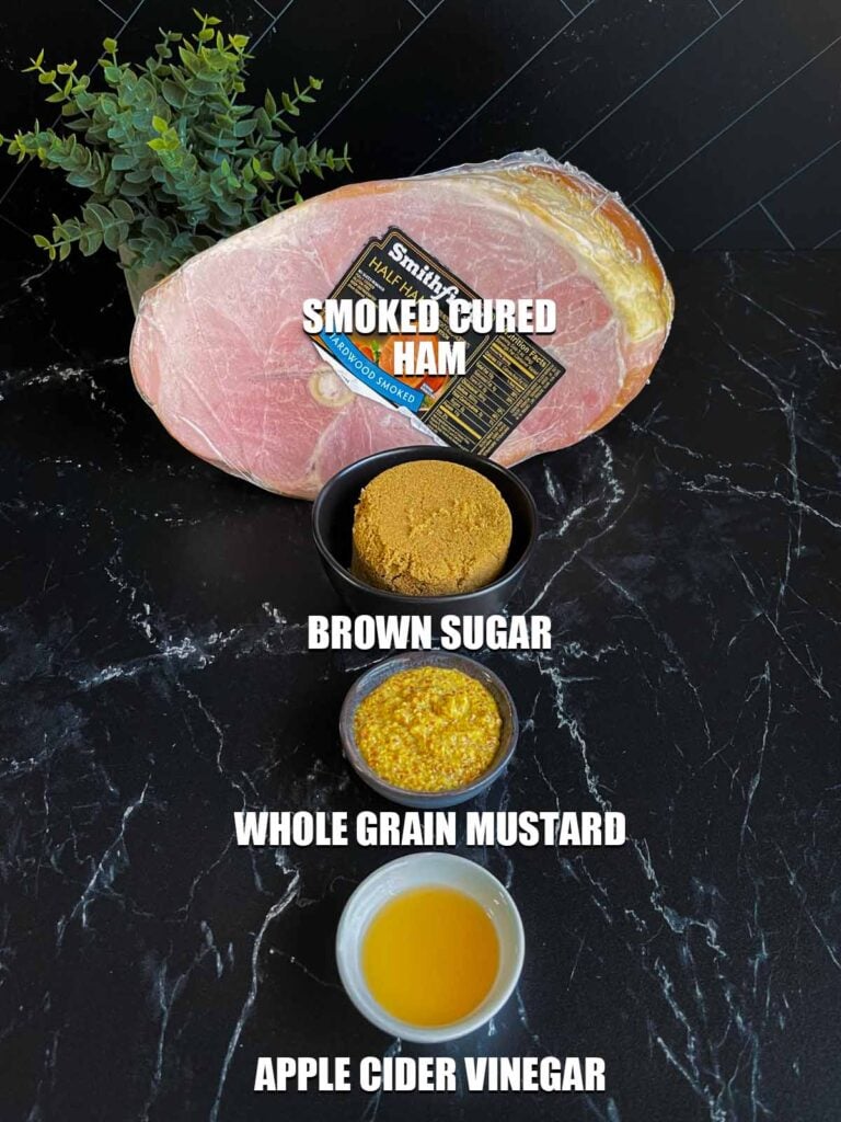 Ingredients for brown sugar glazed ham on a dark surface.