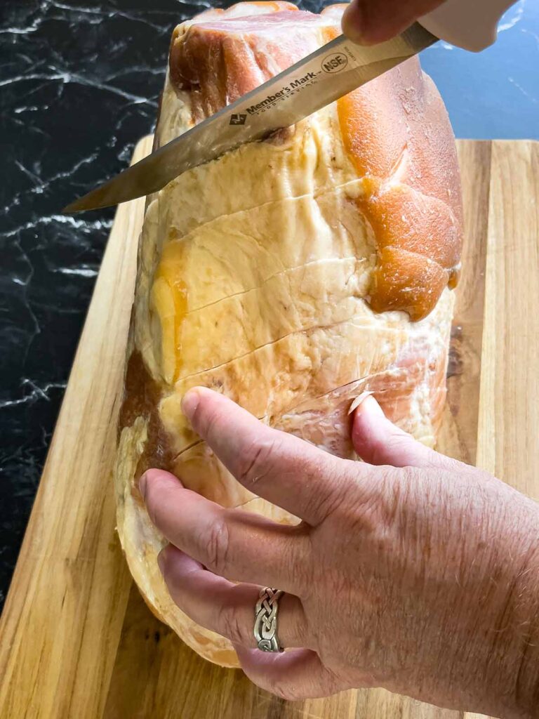 Diagonal slices being cut into the ham.