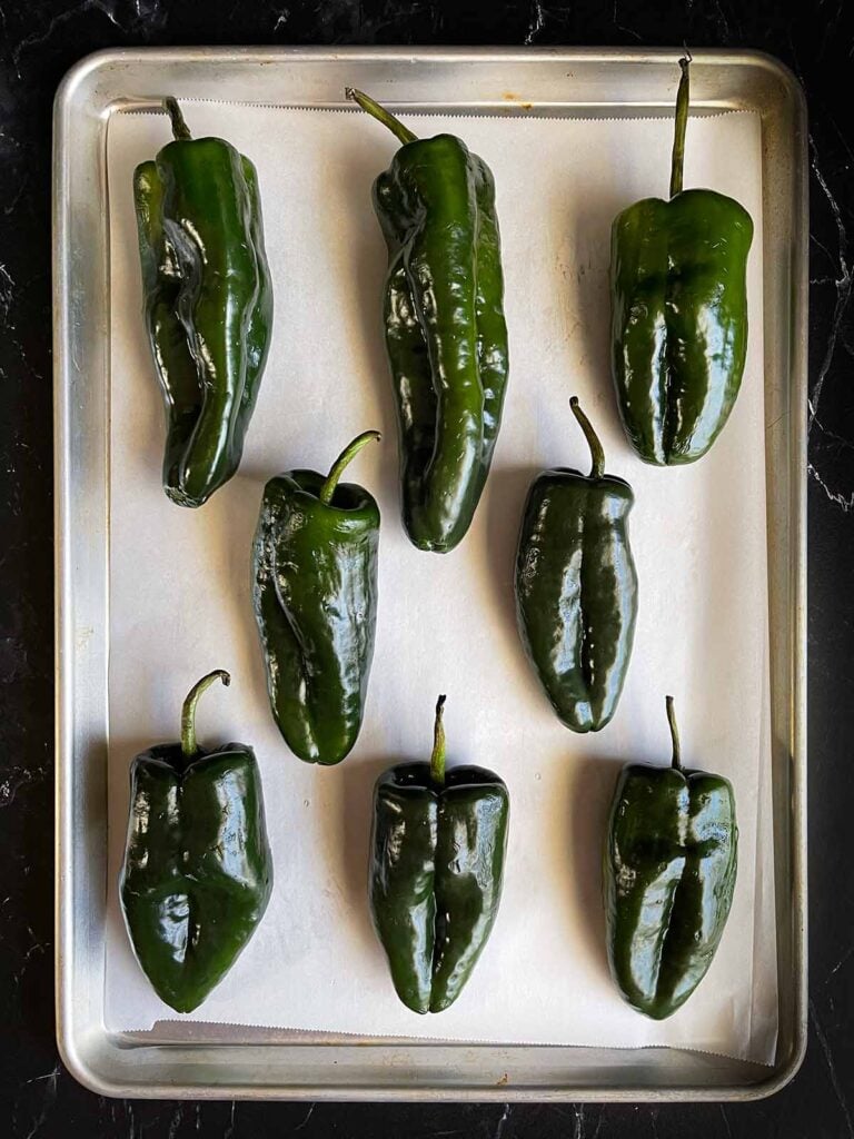 Poblano peppers on a baking sheet.