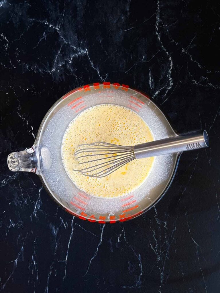 Seasoned egg mixture in a mixing bowl.