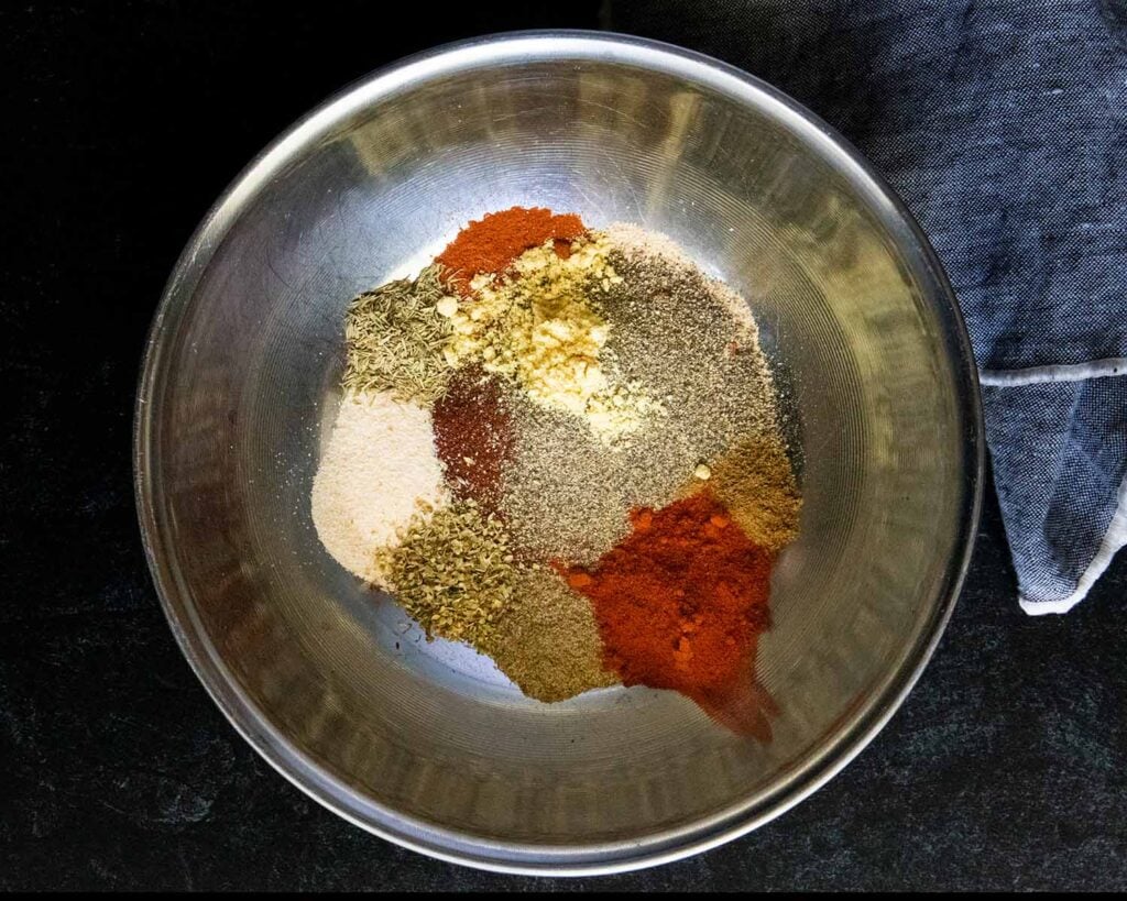 Various herbs and spices in a mixing bowl.