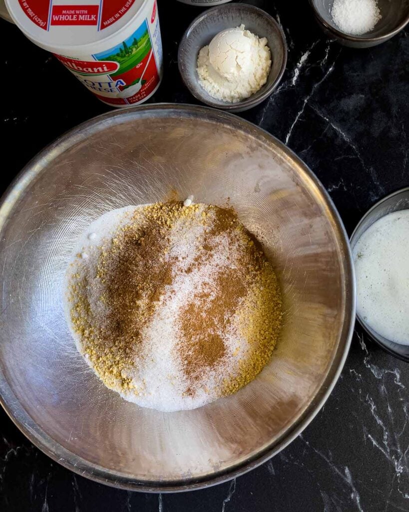 Graham cracker crust ingredients in a metal bowl.