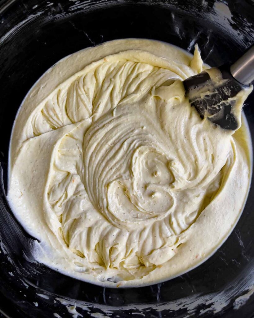 The mixed cannoli cheesecake batter in a glass bowl.