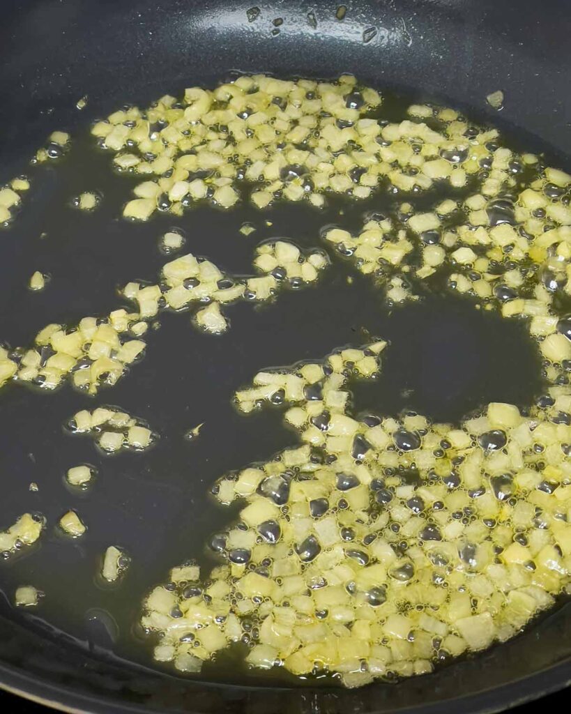 Shallots searing in olive oil.